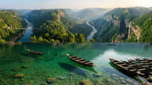 Crystal-clear Umngot River at Dawki along with the scenic river valleys of Meghalaya surrounded by forests and hills.