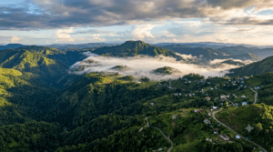 Aerial view of Meghalaya's Khasi, Garo and Jaintia Hills with Shillong Peak, green valleys, forests and mist-covered mountains.