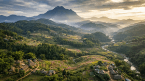 Aerial view of Nagaland featuring Mount Saramati, Naga Hills, Dzukou Valley, forests, rivers, and terraced farms.
