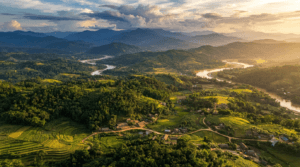 Aerial view of Tripura featuring rolling hills, dense forests, rivers, fertile valleys, agricultural fields, bamboo groves, and rural villages