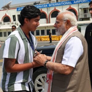 Vaibhav Suryavanshi greeting Prime Minister Narendra Modi during a meeting at Jay Prakash Narayan International Airport in Patna.