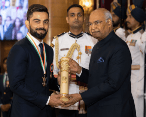 Virat Kohli holding prestigious cricket awards and trophies while representing India.